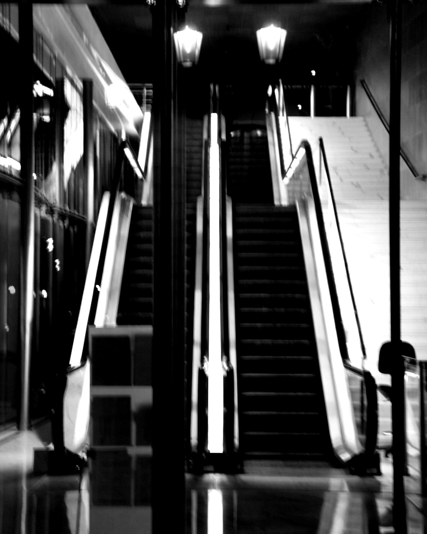 Empty escalators under two lanterns in an underground mall