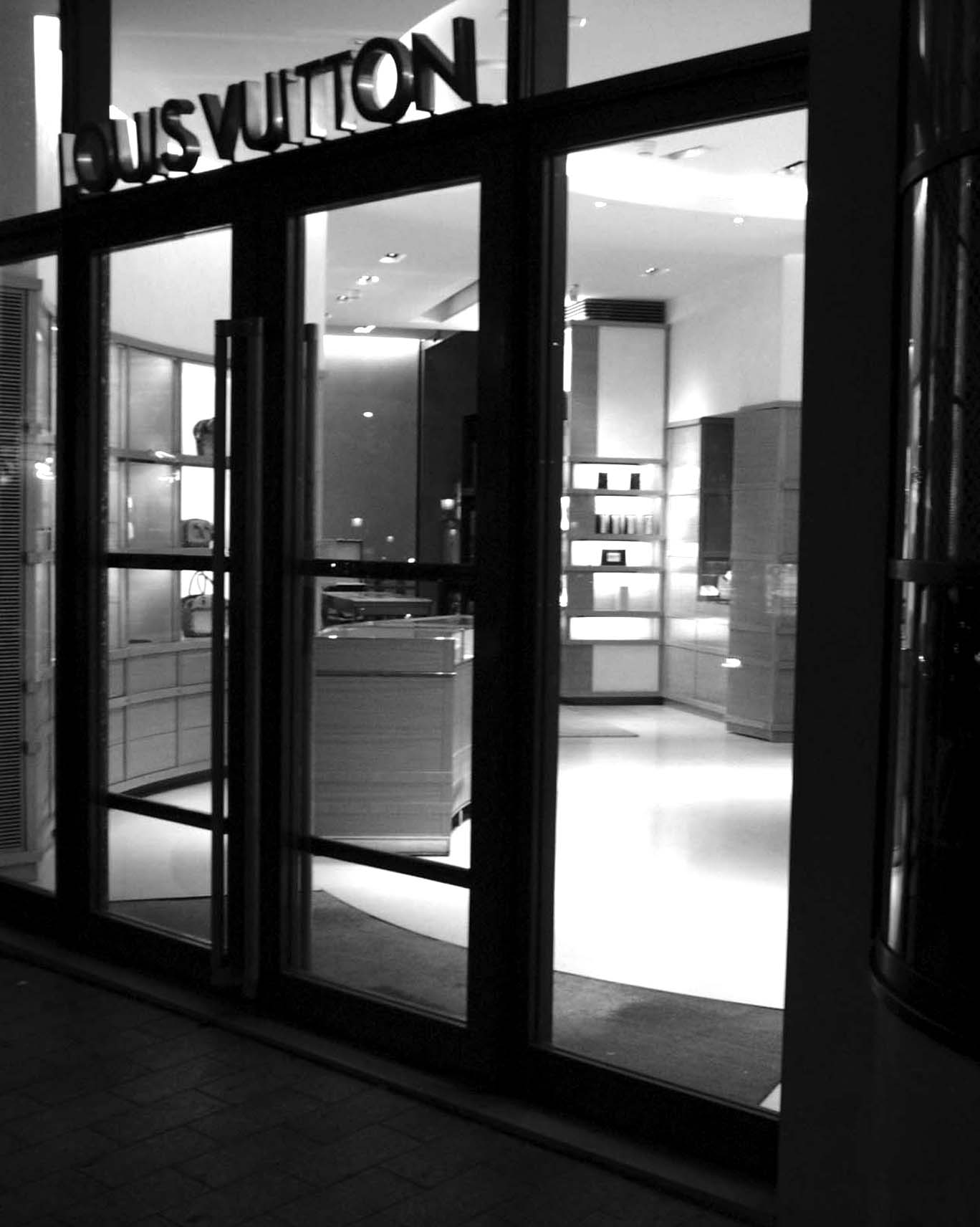 Louis Vuitton shop seen through its glass doors at night