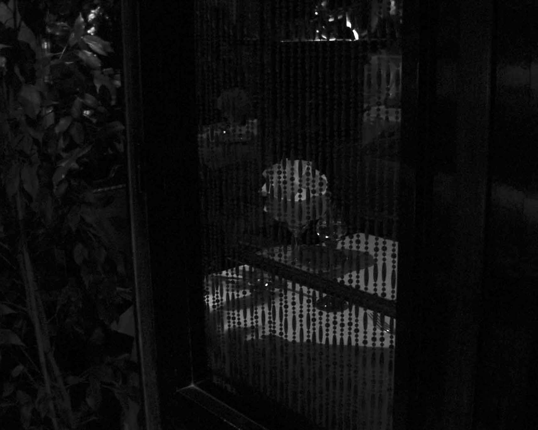 A restaurant table glimpsed through a bead curtain