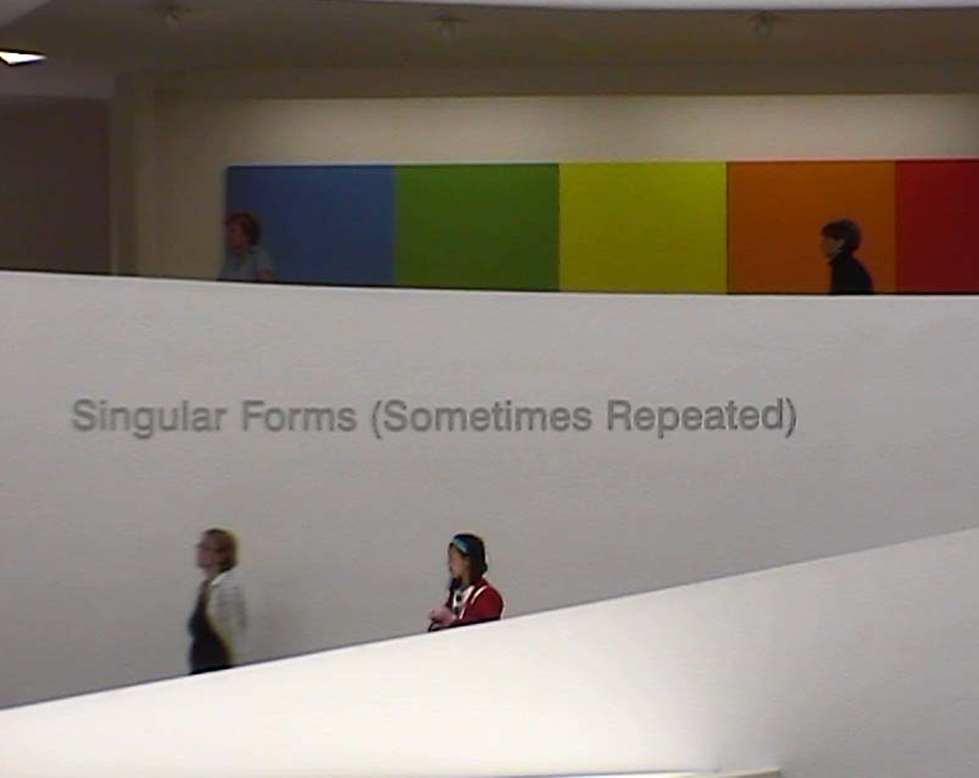 Guggenheim ramp with the words Singular Forms (Sometimes Repeated), colour bands above