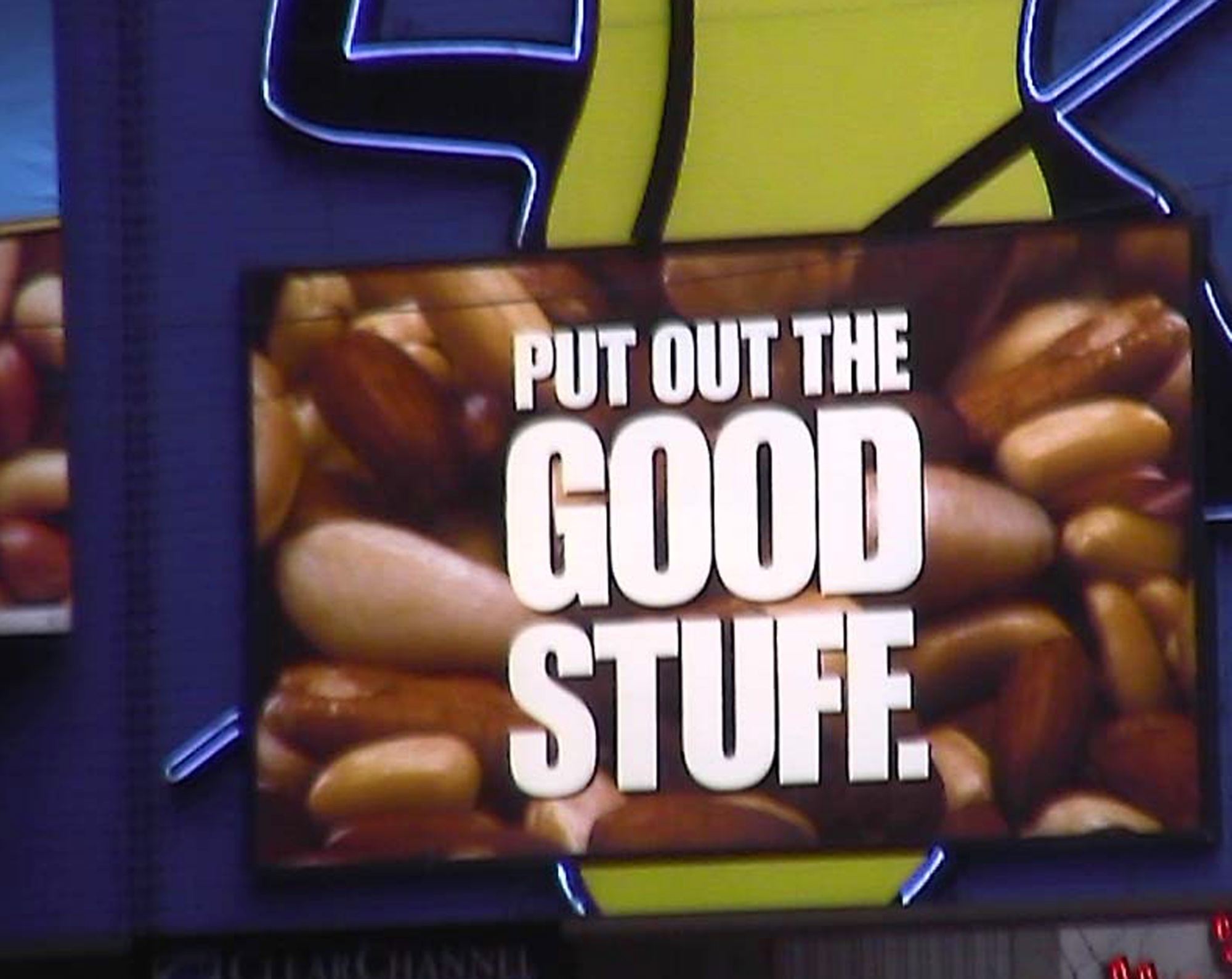 Times Square billboard of nuts reading Put out the good stuff