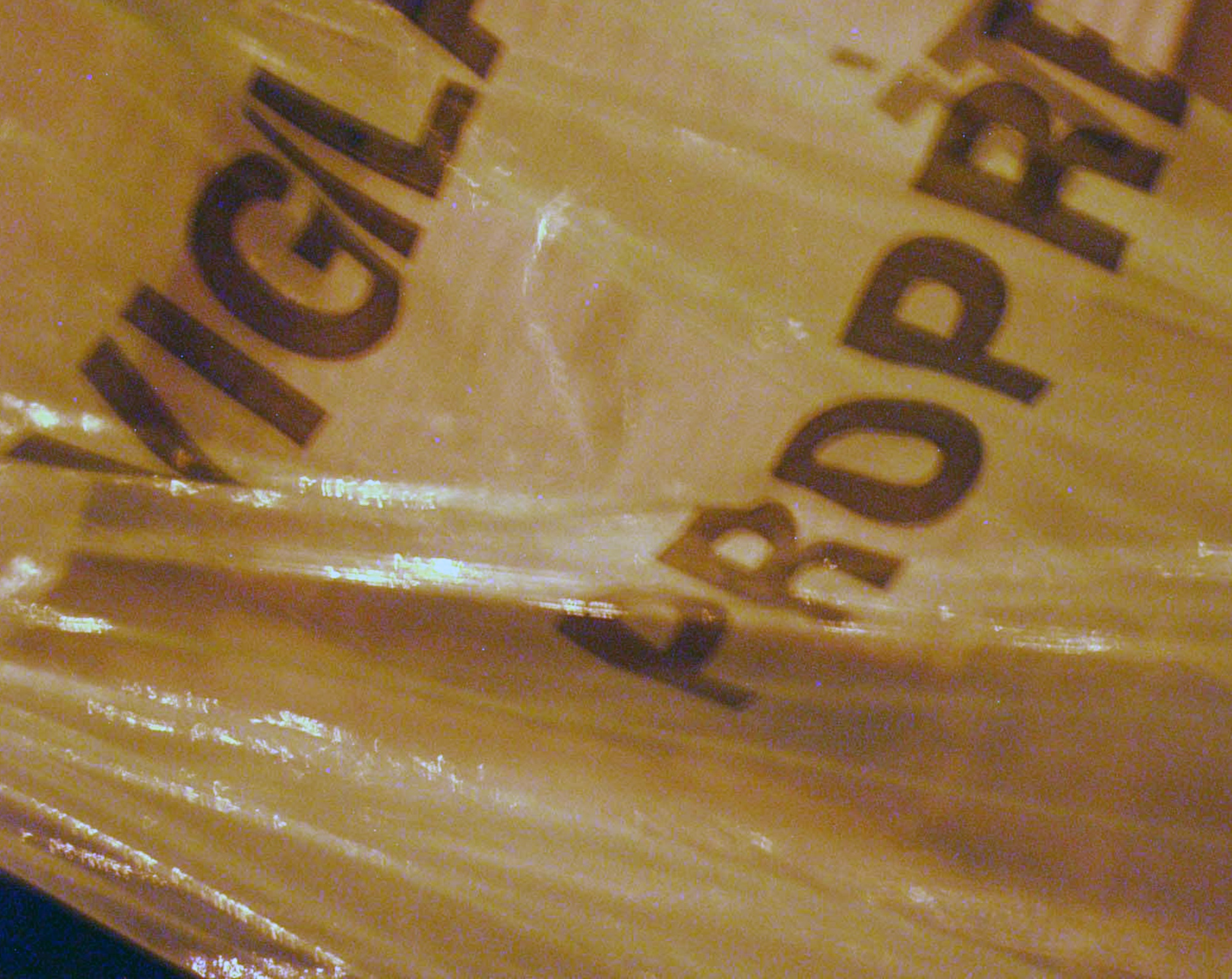 Crumpled plastic sheet printed with the words Vigil and Propre