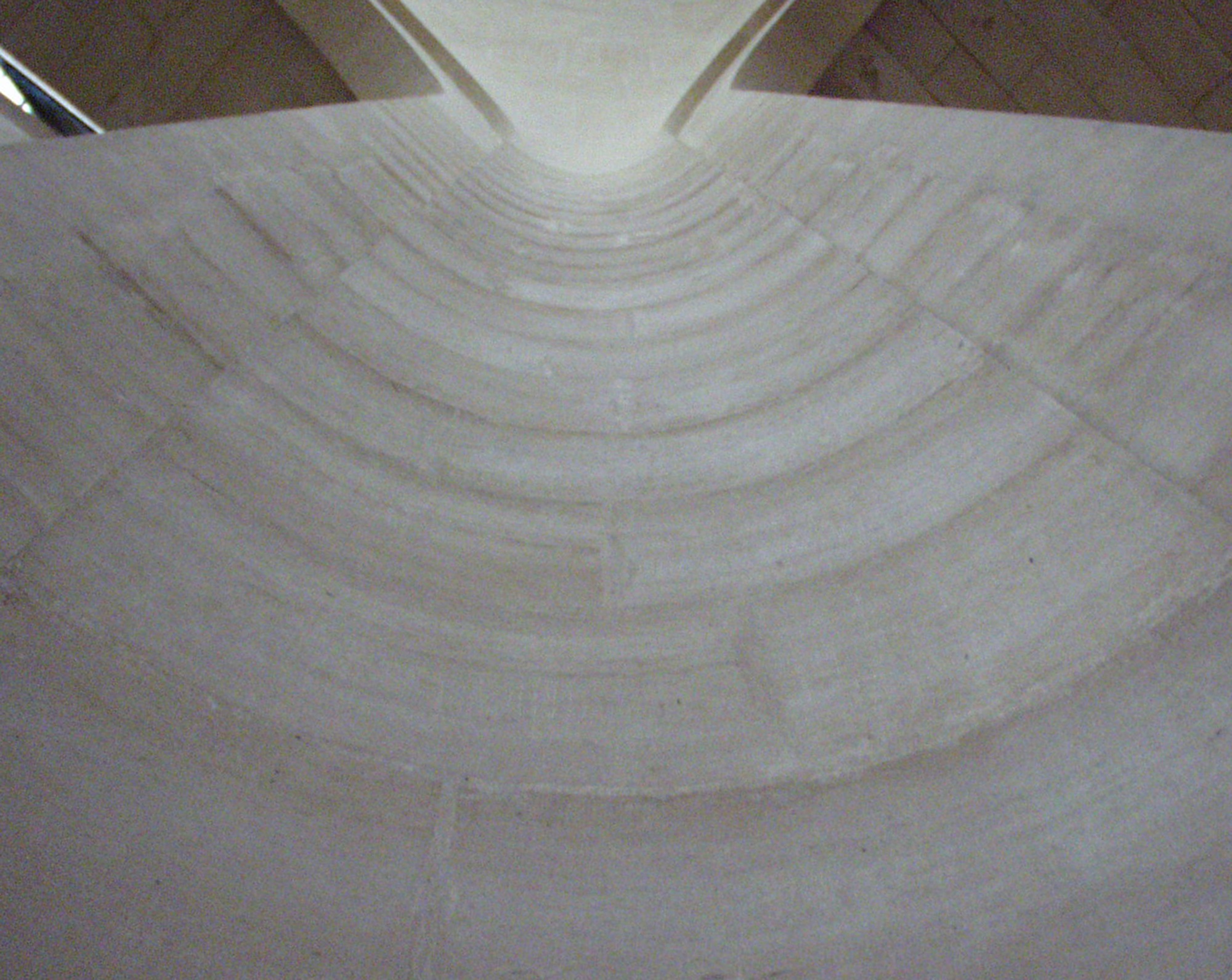 A curved concrete vault seen from below, rings like ripples