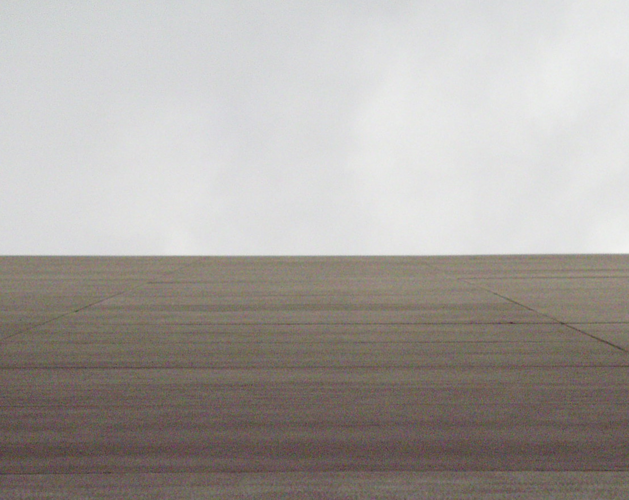A flat concrete wall meeting a pale sky
