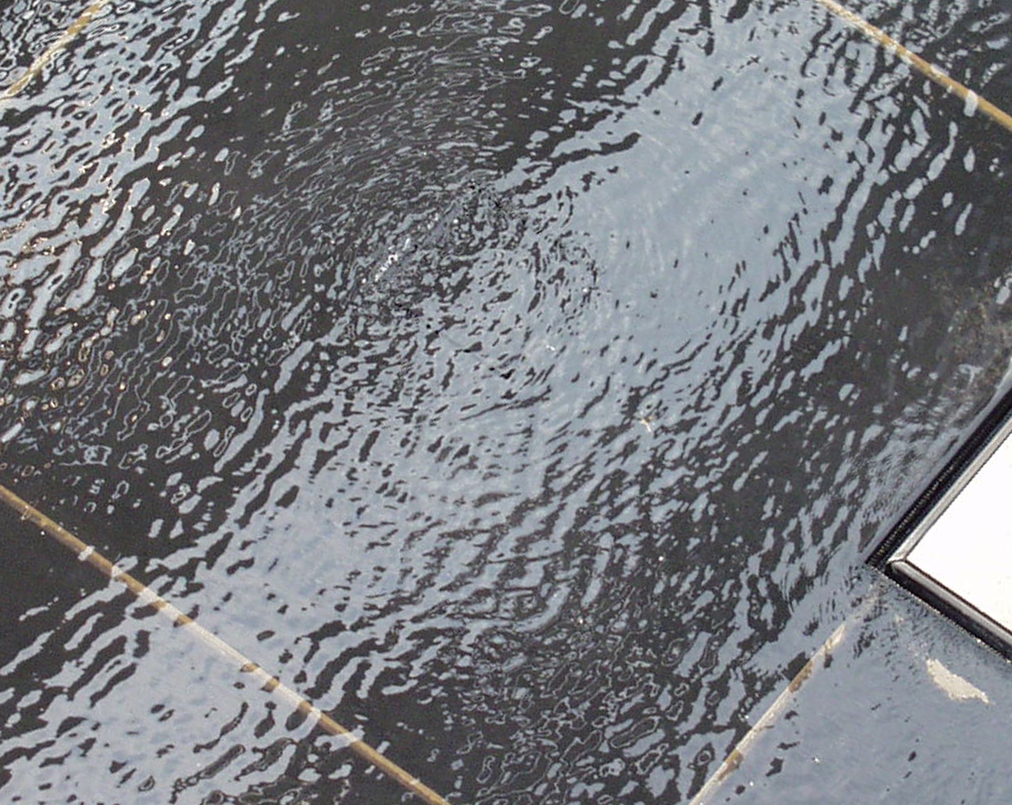 Rippled glass with a small white triangle in one corner