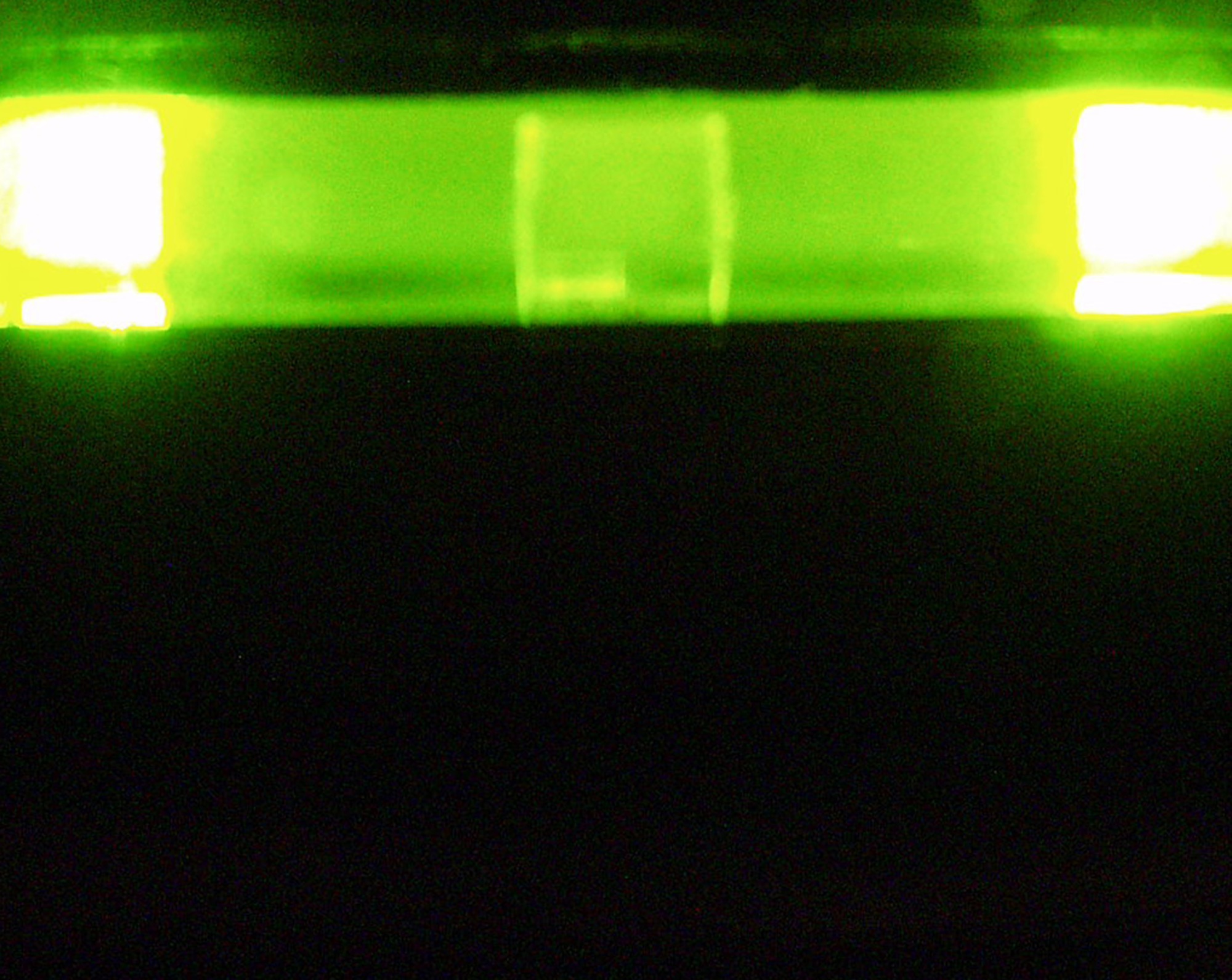 A bar of green light glowing in the dark