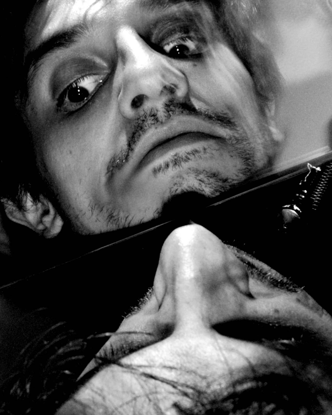 Face tilted against a mirror, reflection seen from below