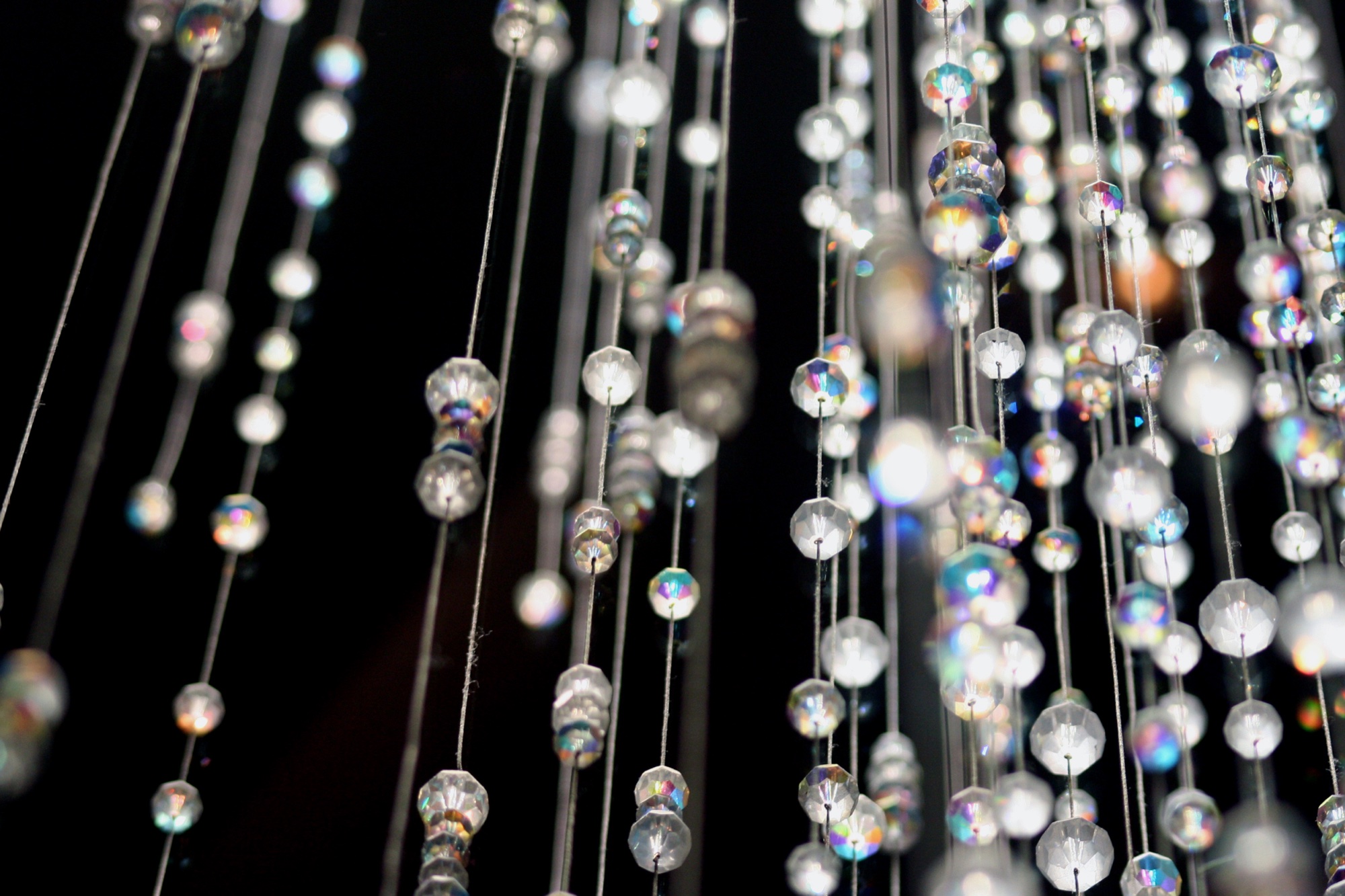Strings of crystal drops against black