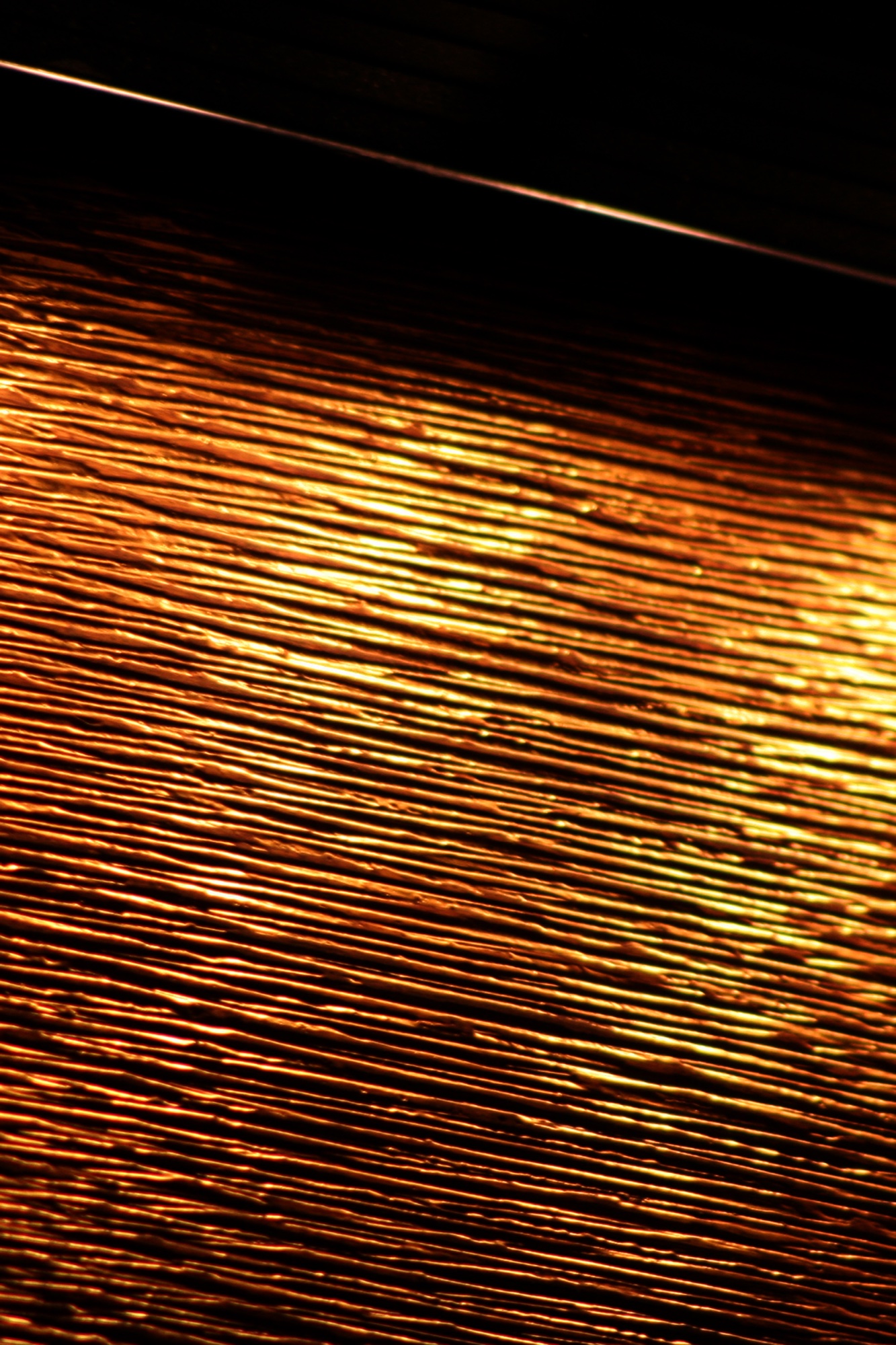 Ribbed wood glowing gold in the dark